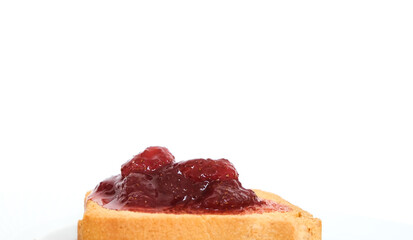 Homemade strawberry jam above sliced toast bread. Breakfast concept. Selective focus. Copy space area.
