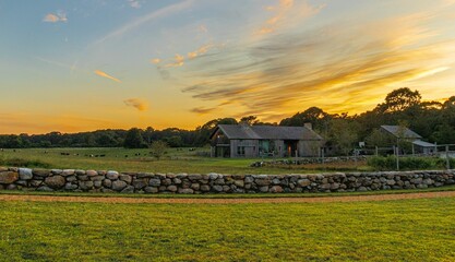 Farmhouse in the field at sunset in Martha's vineyard, Massachusetts, USA - obrazy, fototapety, plakaty