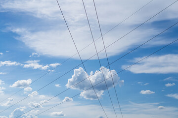 Blue sky and clouds with electric cables.