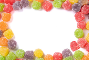 Frame of colorful gum drop candies over whute background with copy space