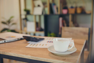 Business executive home office Desk Background concept. Business computer empty home office table with desktop laptop, notebook, coffee, calculator, book, annual, summary report, document, and paper