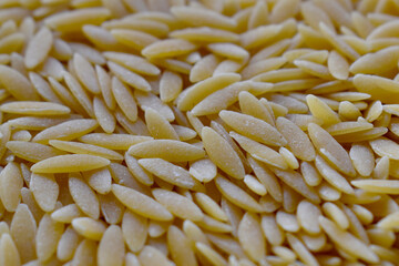 Uncooked risoni pasta with selective focus