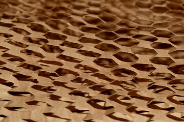 Brown honeycomb packaging paper closeup with selective focus