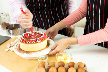 Asian woman and Arab man as Young adult couple learn how to bakery cooking cake online course kitchen. Diverse Family video to cyberspace class on laptop as blogger social media together, copy space