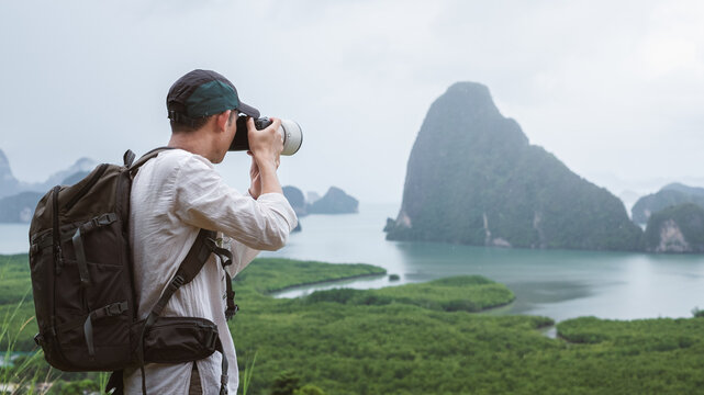 Adventure photographer taking landscape photos. Phang Nga Bay, Samet Nangshe Viewpoint, Thailand