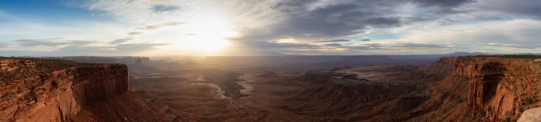 Fototapeta na wymiar Scenic Panoramic View of American Landscape and Red Rock Mountains in Desert Canyon. Cloudy Sunrise Sky. Canyonlands National Park. Utah, United States. Nature Background Panorama