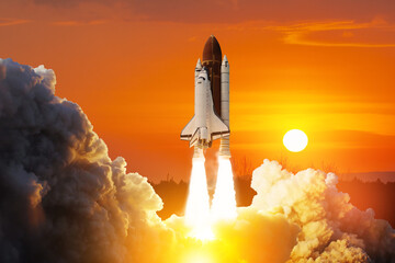 Spaceship lift off. Space shuttle with smoke and blast takes off into space on a background of...