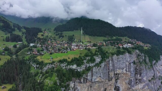 Village of Murren in the Swiss Alps. Village Murren surrounded by mountain peaks of Alps. Murren mountain village with Lauterbrunnen Valley and Swiss Alps, Jungfrau region, Switzerland, Europe.