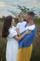 parents hold their son in their arms and have fun. High quality photo