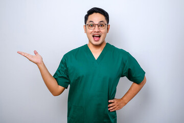 Fototapeta premium Portrait of young asian male medical worker wearing medical gear on white background
