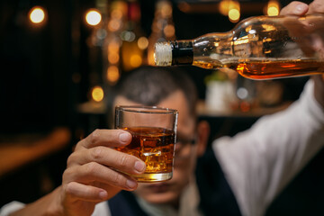 Barman pouring whiskey whiskey glass beautiful night