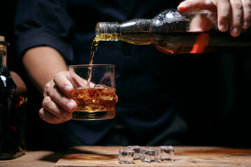 Barman pouring whiskey whiskey glass beautiful night