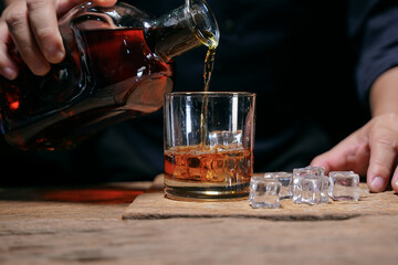 Barman pouring whiskey whiskey glass beautiful night