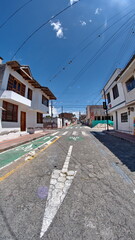 Fototapeta na wymiar Quiet street in a residential area in Cotacachi, Ecuador, taken with a fisheye lens