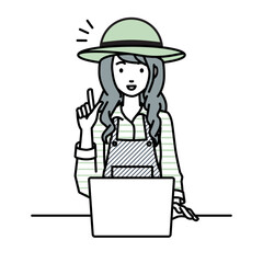 デスクで座ってPCを開いて何かひらめいた農家の女性