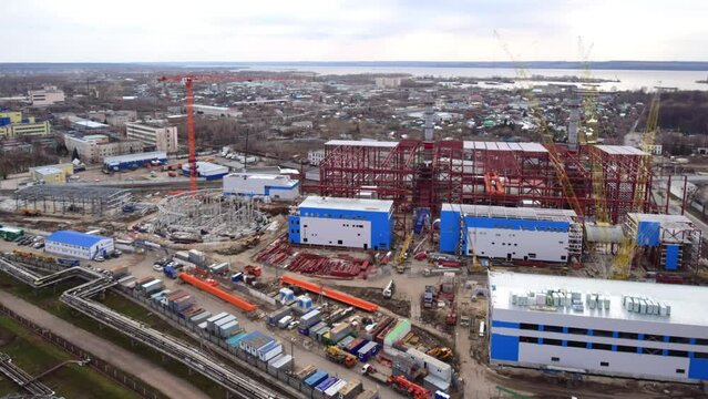 Timelapse of thermal power station building near large city through year. Heating plant contraction site and machinery