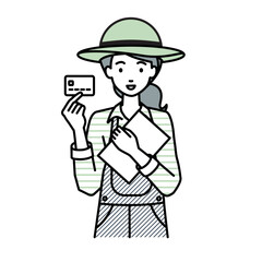 立って書類とカードを手に持つ農家の女性