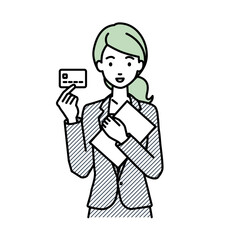 立って書類とカードを手に持つビジネススーツの女性