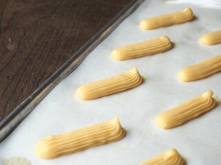 Eclairs piped on baking tray