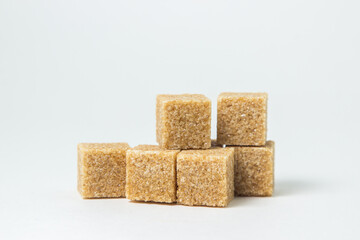 Cane sugar on a white background. Brown refined cane sugar.