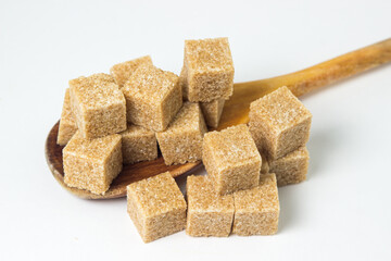 Cane sugar on a white background. Brown refined cane sugar.