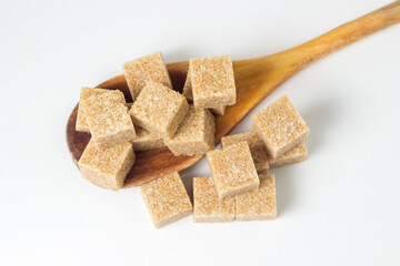 Cane sugar on a white background. Brown refined cane sugar.