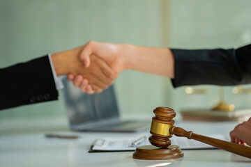 Businessmen shake hands to seal an agreement with a partner lawyer or lawyer who discusses the terms of the contract. The concept of a businessman's legal advisor.