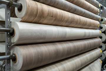Rolls of new linoleum on the window of a hardware store. A large selection of linoleum