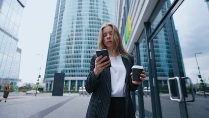 portrait of confident and ambitious business lady in center of big city, woman is walking