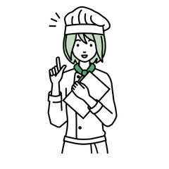 デスクで座ってPCを開いて何かひらめいた調理師の女性