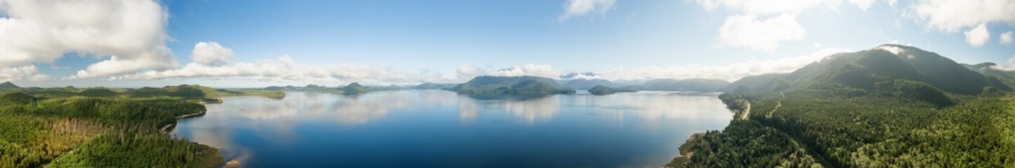 Aerial Panoramic View of Kennedy Lake during a vibrant sunny day. Located on the West Coast of Vancouver Island near Tofino and Ucluelet, British Columbia, Canada. - obrazy, fototapety, plakaty