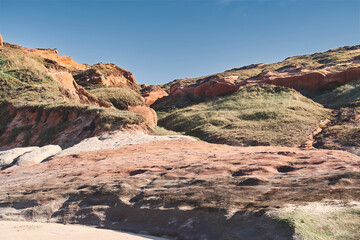Scenic look of rocky hills and grassy terrain on a sunny day in the outdoors