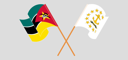 Crossed and waving flags of Mozambique and the State of Rhode Island