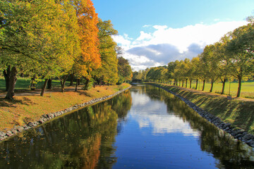 A beautiful autumn landscape with trees and lake. Park canal in autumn fall season, Stockholm,...