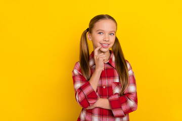 Fototapeta na wymiar Photo of funky thoughtful schoolkid dressed plaid shirt finger lips looking empty space isolated yellow color background
