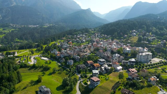 Mountain Alpine Village Aerial Footage in the Dolomites Italy. 4K UHD Aerial Village Video Landscape.