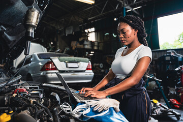 Fototapeta na wymiar Female mechanic wearing gloves checking the engine in the garage.