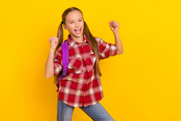 Photo of funny lucky schoolkid dressed plaid shirt rising fists screaming isolated yellow color background