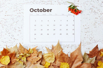 autumn background with October calendar, pyracantha and leaves