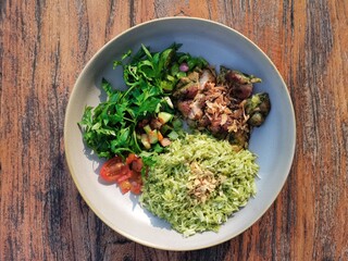 Sauted Beef with Green Basmati Rice and Cosmos leaf, tomatoes and chilly in the afternoon sunset light