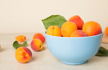 Composition with ripe apricots on wooden table