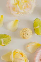 White chocolate candies and lemon slices on white background. Food Styling. Spring and Summer comfort food.