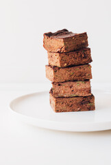 Delicious freshly baked vegan gluten free chocolate brownies made with natural ingridients such as almond flour, banana and zucchini. Sweet healthy food. Alternative sugar free snack.