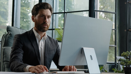 Caucasian busy serious bearded middle-aged 40s man worker in office working online commerce service trade in internet. Adult manager company CEO employee businessman typing on computer concentrated