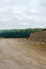 Georgian mountain landscape with a country road, a view of the woodlands