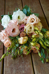 A pile of lisianthus flowers placed on a wood plank floor. Colorful flowers.