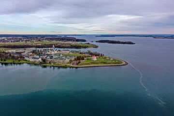 View of RMC, from water from Kingston Ontario with Fort Henry in background