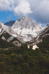 Marble quarry in Carrara, in Tuscany region, Italy. Famous location and place of interest. Mountain view with white marble rock and blue sky.