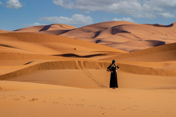 A Beautiful Model Poses In The Sand Dunes In The Great Sahara Desert In Morocco, Africa
