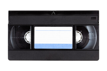 Old black vintage vhs cassette tape front with a blank paper label, front side, top view isolated...